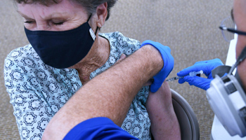 A woman receives a shot of the Pfizer vaccine at a walk-in COVID-19 vaccination POD in Leesburg, US - 29 January (Paul Hennessy/SOPA Images/Shutterstock)