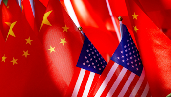 US flags are displayed together with Chinese flags on top of a trishaw in Beijing, September 2018 (Andy Wong/AP/Shutterstock)