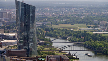 A cargo vessel travelling on the river Main passes the ECB headquarters in Frankfurt, Germany, July 2018 (Mauritz Antin/EPA-EFE/Shutterstock)