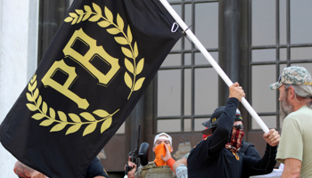 A protester carries a Proud Boys banner, 7 September 2020 (Andrew Selsky/AP/Shutterstock)