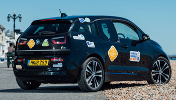 An electric vehicle with colourful bumper stickers designed to help dispel common misconceptions around them (PinPep/Shutterstock)