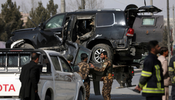 A car damaged by a bomb is removed from a Kabul street (Rahmat Gul/AP/Shutterstock)