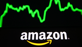 Amazon logo in front its stock price graph (Pavlo Gonchar/SOPA Images/Shutterstock)