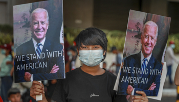 Demonstrators display pictures of US President Joe Biden during a protest against the military coup in Yangon, Myanmar, 17 February (STR/AP/Shutterstock)