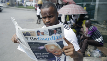 A Nigerian man reads a newspaper reacting to President Joe Biden’s election win, November 8, 2020 (Sunday Alamba/AP/Shutterstock)