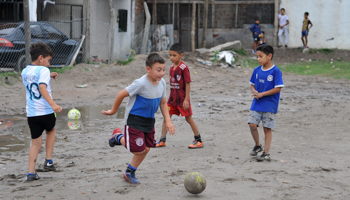 Children playing football at the Estrella Roja club in Villa Fiorito, where Diego Maradona got his start (Isabel Mateos/AP/Shutterstock)