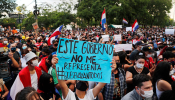 Asuncion protesters with a banner reading "This government doesn't represent me. All of them out" (Jorge Saenz/AP/Shutterstock)
