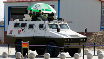 Paramilitary policemen in an armoured vehicle in Xinjiang (Ng Han Guan/AP/Shutterstock)