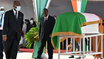 Ivorian President Alassane Ouattara (C) walks past the coffin of the late Prime Minister Hamed Bakayoko during his official tribute ceremony at the presidential palace in Abidjan, March 17 (Issouf Sanogo/POOL/EPA-EFE/Shutterstock)