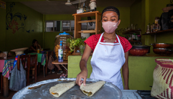 A woman working at a restaurant in Pochutla, Mexico (Antonio Cascio/SOPA Images/Shutterstock)