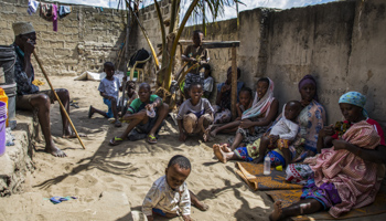 Displaced persons sit outside an overcrowded house in the Paquitequete district of Pemba, Cabo Delgado, after fleeing insecurity, July 21, 2020 (Richardo Franco/EPA-EFE/Shutterstock)