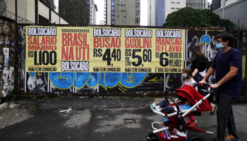 A banner protesting high prices and low wages, referring to Bolsonaro as "Bolso-expensive" and "Brazil in intensive care" (Cris Faga/NurPhoto/Shutterstock)