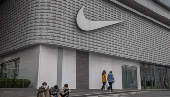 People sit next to a Nike store in Beijing, China, 27 March (Roman Pilipey/EPA-EFE/Shutterstock)