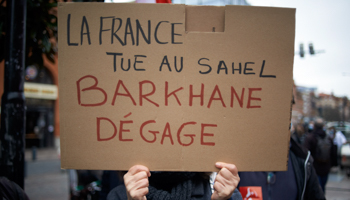 Cardboard reading 'France kills in Sahel, Barkhane Get out!' at a protest in Toulouse, France, in February (Alain Pitton/NurPhoto/Shutterstock)