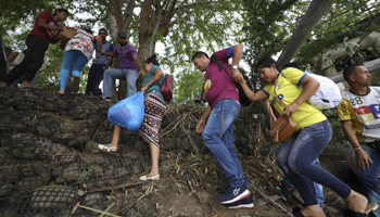 Venezuelans cross into Colombia following clashes between Venezuelan soldiers and Colombian armed groups (Fernando Vergara/AP/Shutterstock)