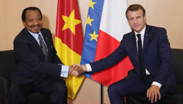 Cameroon’s President Paul Biya (L) with France's President Emmanuel Macron (R) shake hands prior to bilateral talks in Lyon, France, October 10, 2019 (Laurent Cipriani/POOL/EPA-EFE/Shutterstock)