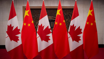 Canadian and Chinese flags hang prior to a meeting between Canada's Prime Minister Justin Trudeau and China's President Xi Jinping at the Diaoyutai State Guesthouse in Beijing on December 5, 2017 (Fred Dufour/Pool/EPA-EFE/Shutterstock)