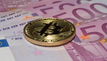 Bitcoin on 500 euro notes (Siegra Asmoel/imageBROKER/Shutterstock)