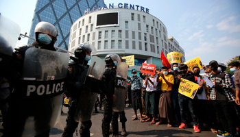 Anti-coup protesters and riot police outside a shopping mall in Yangon (Uncredited/AP/Shutterstock)