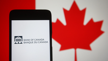 A smartphone displays the Bank of Canada logo beside a Canadian flag (Pavlo Gonchar/SOPA Images/Shutterstock)