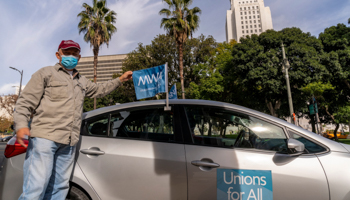 Uber driver Jose Luis Guevara, a member of the Mobile Workers Alliance, pauses for a picture outside Los Angeles City Hall, January 12 (Damian Dovarganes/AP/Shutterstock)