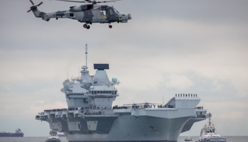 UK navy helicopter and aircraft carrier (Rob Arnold/LNP/Shutterstock)