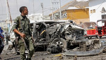 A solider passes the wreckage from a car bomb near the presidential palace, February 13 (Farah Abdi Warsameh/AP/Shutterstock)