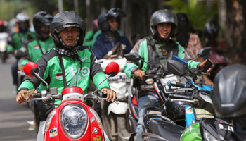 Go-Jek drivers wait for customers in Jakarta (Achmad Ibrahim/AP/Shutterstock)