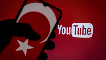 A Turkish flag displayed on a smartphone with a YouTube logo in the background (Tunahan Turhan/SOPA Images/Shutterstock)