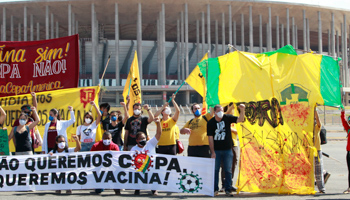 Protesters against the Copa America football tournament, with a banner reading "We don't want the Cup, we want vaccines!" (Ailton de Freitas/AP/Shutterstock)