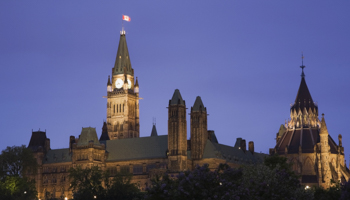 The Canadian Parliament building and Peace Tower illuminated at dusk, Ottawa, Ontario, Canada (ImageBroker/Shutterstock)