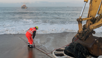 Workers preparing to land a Google submarine cable, March 2020 (Mario Fourmy/SIPA/Shutterstock)