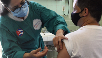 A medical worker administers a dose of Soberana 02 to a volunteer in Havana, Cuba, March 31 (Xinhua/Shutterstock)