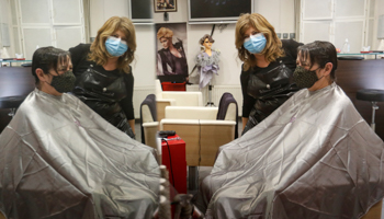 Hairdresser Andrea Roder reflected in a mirror with a customer, the day some government lockdown restrictions were lifted in Hungary, Budapest, April 7 (Laszlo Balogh/AP/Shutterstock)