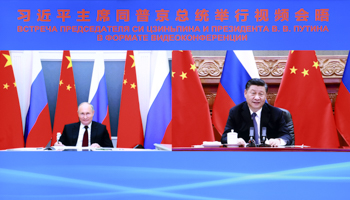 Chinese President Xi Jinping (R) talks to Russia's Vladimir Putin via video link, June 28 (Xinhua/Shutterstock)