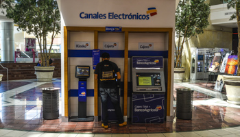 A man performs a transaction at a bitcoin ATM in San Salvador (Camilo Freedman/SOPA Images/Shutterstock)