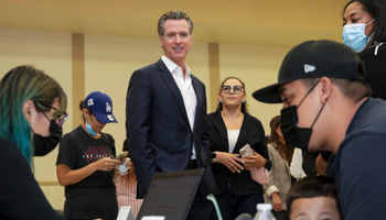 Gov. Gavin Newsom with applicants for the nation's largest rent relief programme at a press conference in California, July 14 (Irfan Khan/Los Angeles Times/Shutterstock)