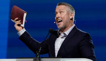 Southern Baptist Convention President J. D. Greear holds a Bible as he speaks during the denomination's annual meeting in Nashville, June 15 (Mark Humphrey/AP/Shutterstock)