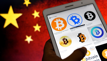 Bitcoin logos shown on a smartphone with the Chinese flag in the background (Avishek Das/SOPA Images/Shutterstock)