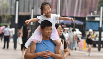 A father carries his daughter on his shoulders in Beijing (Sheldon Cooper/SOPA Images/Shutterstock)