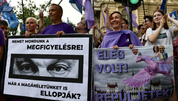 Banners showing Prime Minister Viktor Orban’s eyes, saying (L) "We have to say No to observation!'' and ''Have they stolen our private life?", left, and (R) "It was enough! Fly!" at a protest against alleged government use of spyware on opponents, Budapest, July 26 Hungary (Anna Szilagyi/AP/Shutterstock)