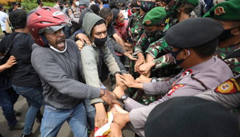 Papuan activists scuffling with Indonesian police and soldiers during a pro-independence rally in Jakarta in December 2020 (Dita Alangkara/AP/Shutterstock)