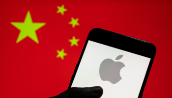 Apple logo seen on an mobile device with the Chinese flag in the background (Budrul Chukrut/SOPA Images/Shutterstock)