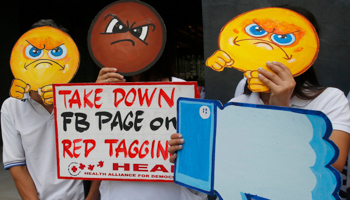 People picket Facebook's office to protest its alleged inaction against fake news, hate speech and vilification campaigns targetting health activists in Manila, Philippines. (Bullit Marquez/AP/Shutterstock)