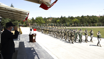 Defence Minister Hulusi Akar salutes Turkish troops who had been were running Kabul’s international airport, at a ceremony at Ankara airport, Ankara, August 28 (Uncredited/AP/Shutterstock)