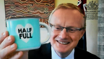 Governor of the Reserve Bank of Australia (RBA) Philip Lowe holds up a mug reading 'Half Full' as he appears by video before a parliamentary committee in Canberra, August 6, 2021 (LUKAS COCH/EPA-EFE/Shutterstock)