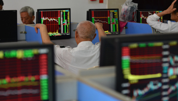A Chinese stockholder looks at stock market data on a computer screen (Sheldon Cooper/SOPA Images/Shutterstock)