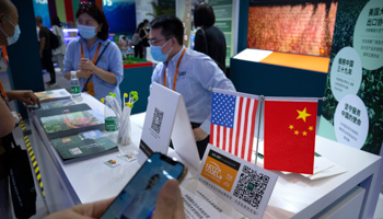 Participants at the China International Fair for Trade in Services (CIFTIS) stand US and Chinese flags, Beijing, September 3 (Mark Schiefelbein/AP/Shutterstock)