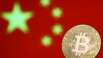 Representation of Bitcoin with the Chinese flag in the background (Jakub Porzycki/NurPhoto/Shutterstock)