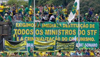 Bolsonaro supporters in Brasilia with banners calling for impeachment of the Supreme Court, paper ballots and criminalisation of communism (Eraldo Peres/AP/Shutterstock)